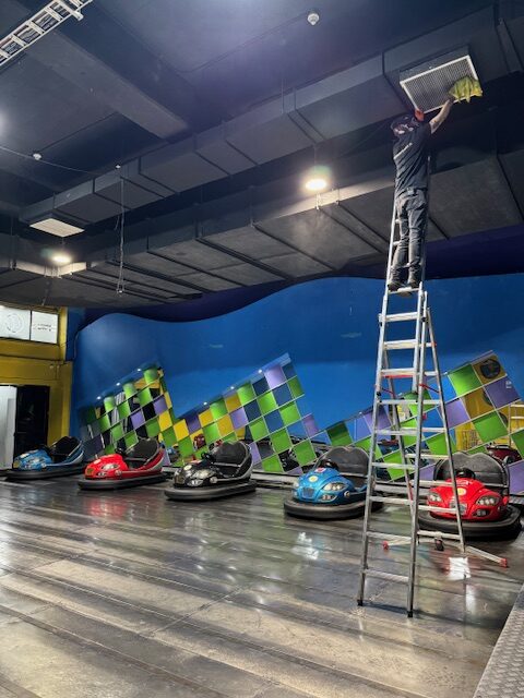 Técnico INGEGAR en escalera trabajando en cielo de local Happyland